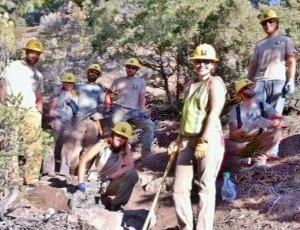 Teens in hardhats working on the trail