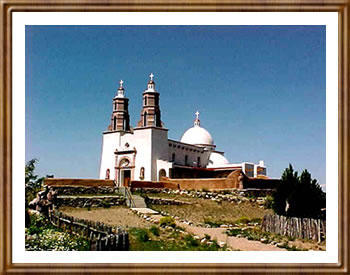 White church with stone steps leading to it